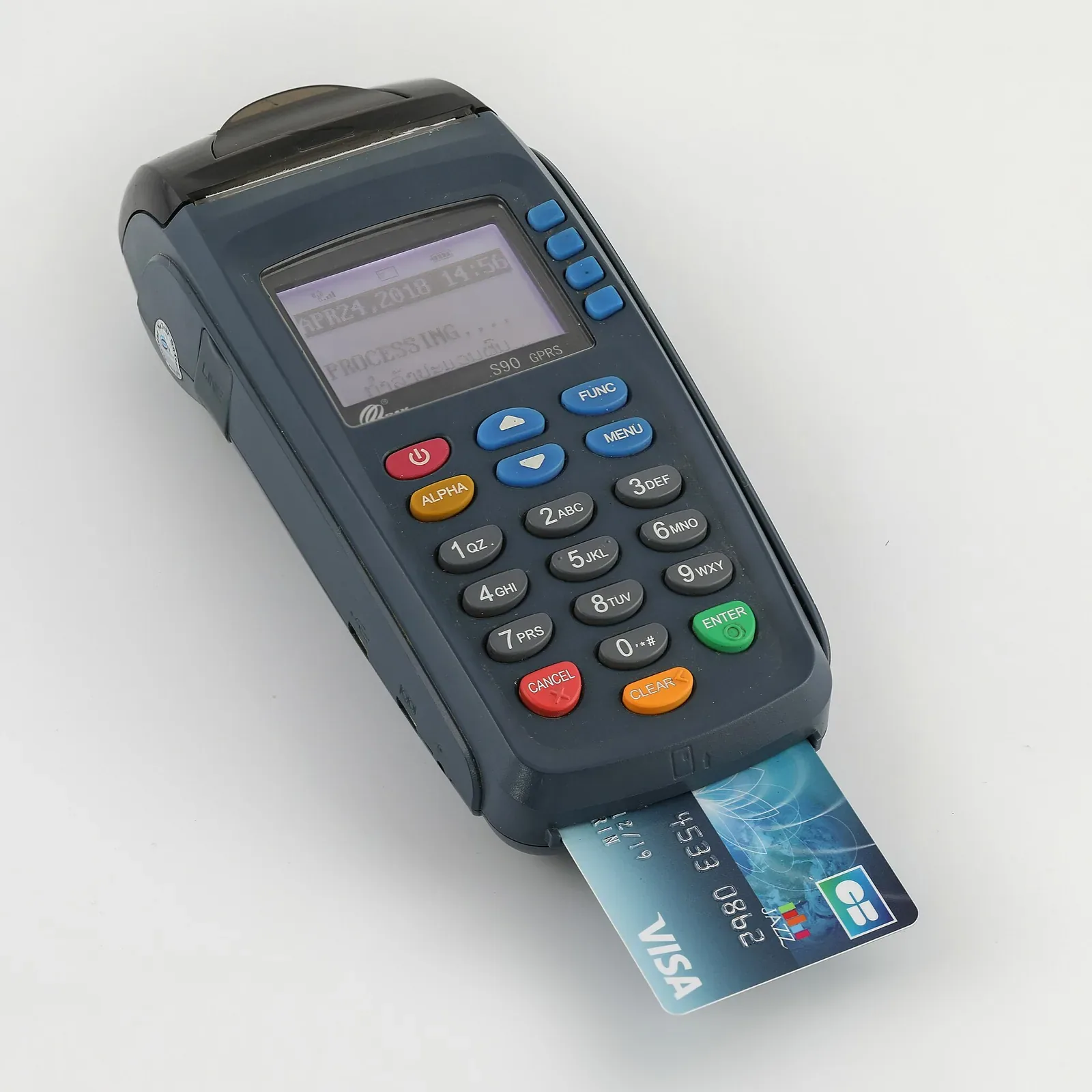 A handheld card payment terminal showing 'Processing' on its screen, with a Visa card inserted in the reader slot