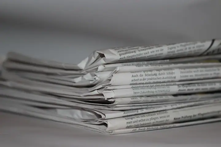 Close-up of a stack of folded newspapers lying on a table