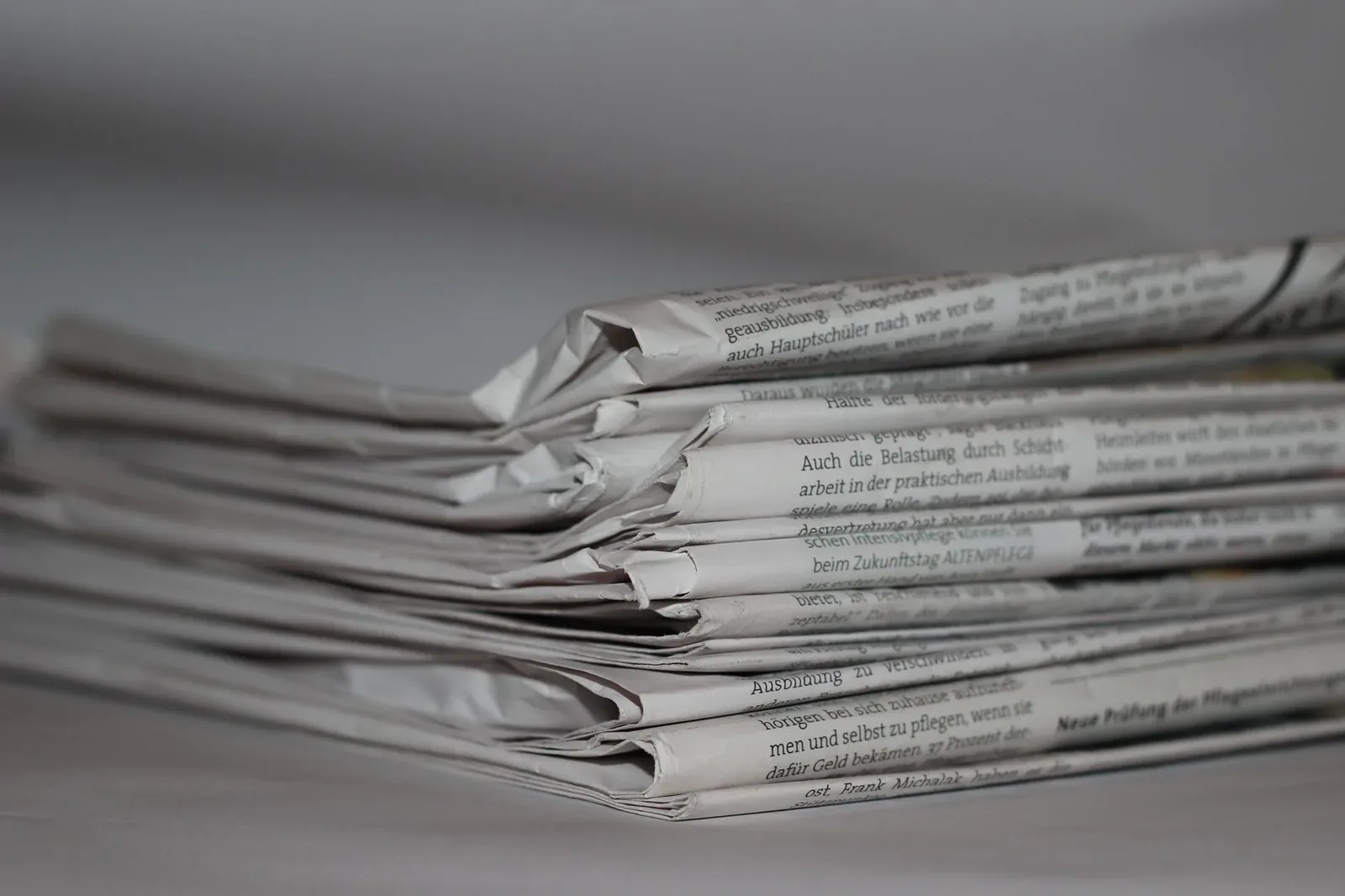 Close-up of a stack of folded newspapers lying on a table